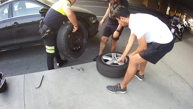 Trafik polisi gençlerin yardımına koştu, araçlarının lastiğini değiştirdi