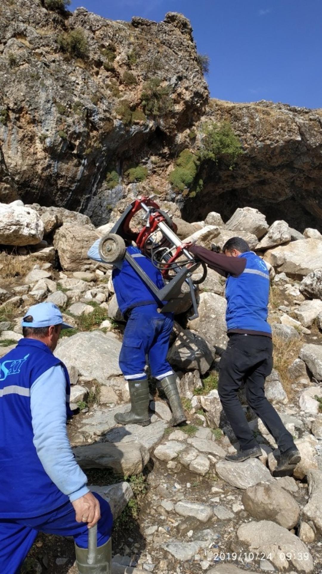Su hattını &ccedil;ekmek i&ccedil;in engebeli arazide jenerat&ouml;r ve 315&rsquo;lik boruları sırtlarında taşıdılar