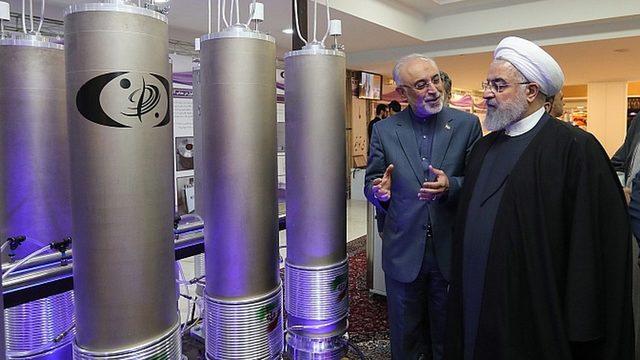 Iranian President Hassan Rouhani (R) had threatened to restart enrichment if sanctions continued