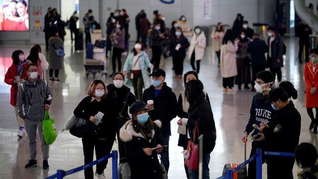 Passengers wearing masks at the Pudong International Airport in Shanghai