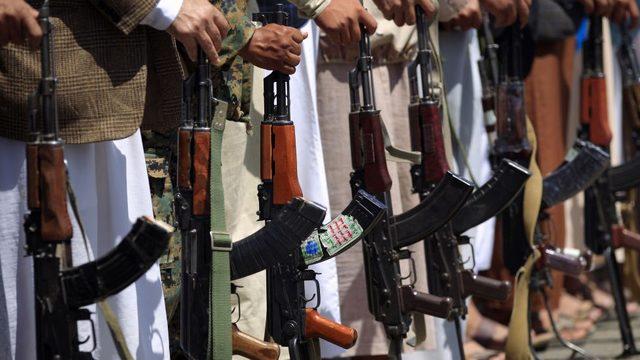 Tribal gunmen loyal to the Huthi movement brandish their weapons during a gathering in the Yemeni capital Sanaa