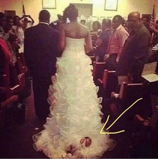 1_Bride-slammed-for-tying-her-BABY-to-her-wedding-gown-before-walking-down-the-aislejpgThe