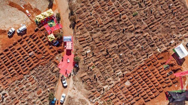 This aerial picture shows several funerals being celebrated at the Olifantsvlei Cemetery in Soweto, on July 25, 2020
