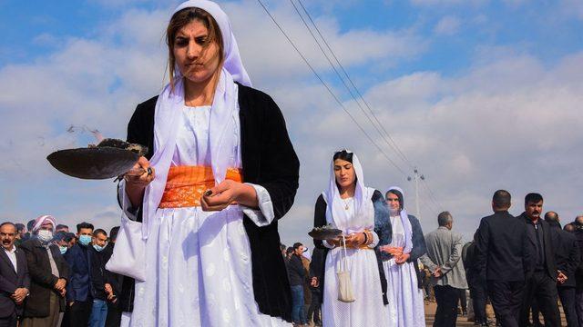 Women burn incense during a procession at the mass funeral in Kocho on 6 February 2021