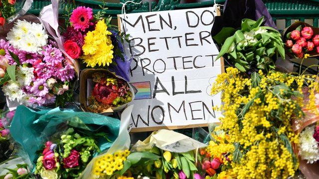 Flowers and a sign that reads 