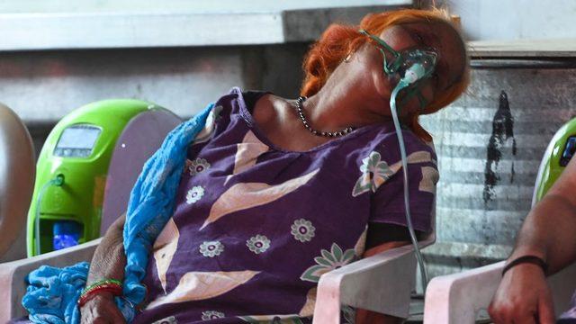 A woman receives oxygen via a mask