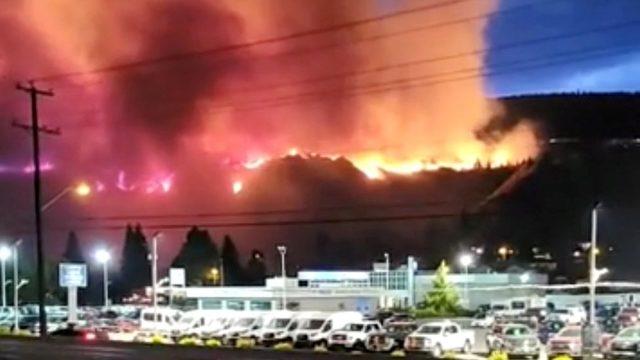 A wildfire burns on a hill in Kamloops, British Columbia, Canada, 1 July 2021