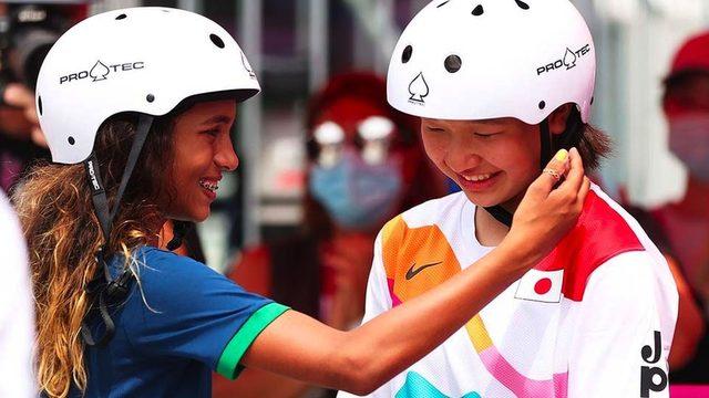 Rayssa Leal of Team Brazil puts her hand up to the face of Momiji Nishiya of Team Japan during the Women's Street Final on day three of the Tokyo 2020 Olympic Games