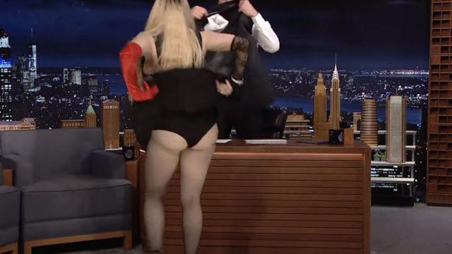 Madonna canlı yayında kalçasını göstermek için masaya atladı