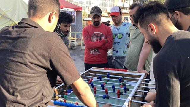 Men play table football at a protest camp set up by supporters of Iran-backed Shia Muslim militias in Baghdad, Iraq