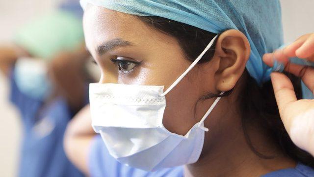 Doctor putting on face mask