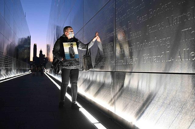 Claudia Castano, New Jersey'deki anıtta 11 Eylül saldırılarında hayatını kaybeden kardeşi German'ın ismine dokunuyor. Saldırıların 20'nci yıl dönümünde Başkan Joe Biden da hayatını kaybeden 2 bin 977 kişi için anma mesajı yayımladı.