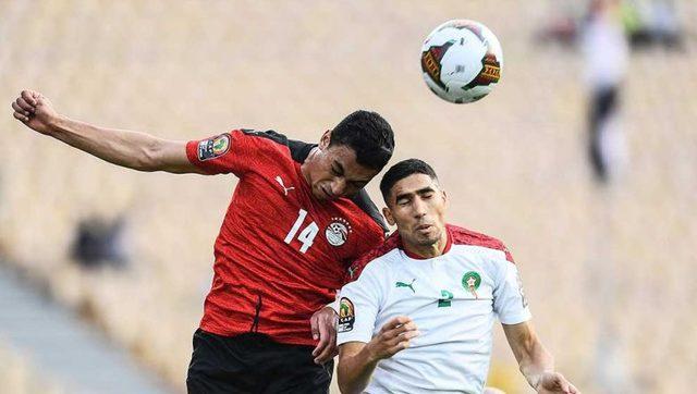 egypt_forward_mostafa_mohamed_left_and_morocco_defender_achraf_hakimi_jump_for_the_ball_during_the_africa_cup_of_nations_2021_quarter-final_football_match_on_sunday._afp