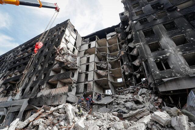 Emergency workers remove debris of a building destroyed in the course of the Ukraine-Russia conflict, in Mariupol