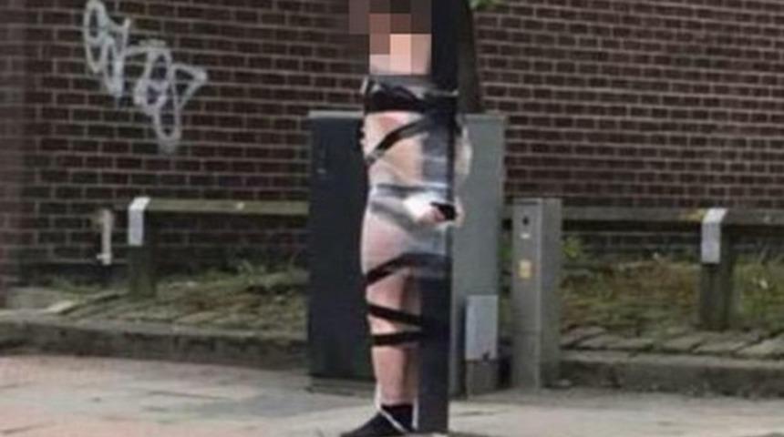 Yarı çıplak halde elektrik direğine bantladılar