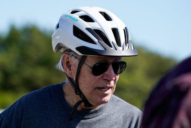 U.S. President Joe Biden rides a bike in Rehoboth Beach, Delaware