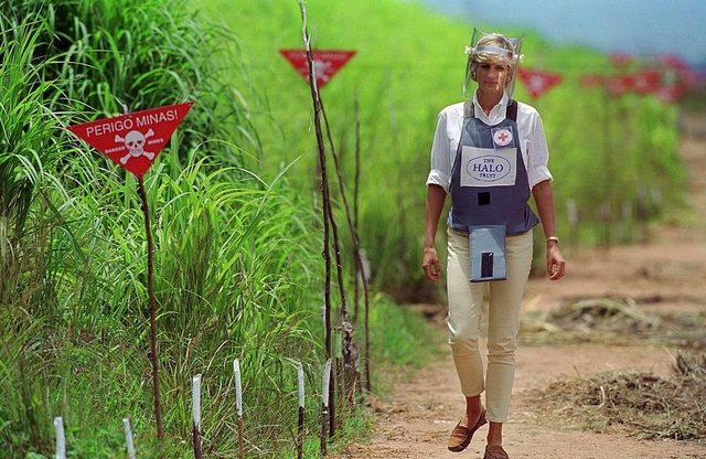 Diana, Princess of Wales wearing protective body armour and a visor visits a landmine minefield being cleared by the charity Halo in Huambo
