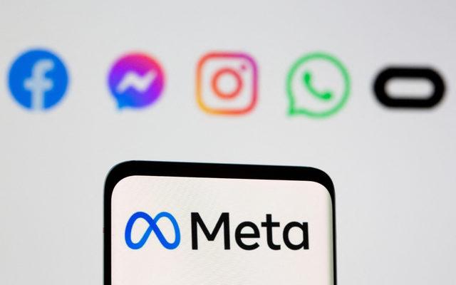 FILE PHOTO: The Meta logo is seen on smartphone in front of displayed logo of Facebook, Messenger, Instagram, WhatsApp, Oculus in this illustration taken