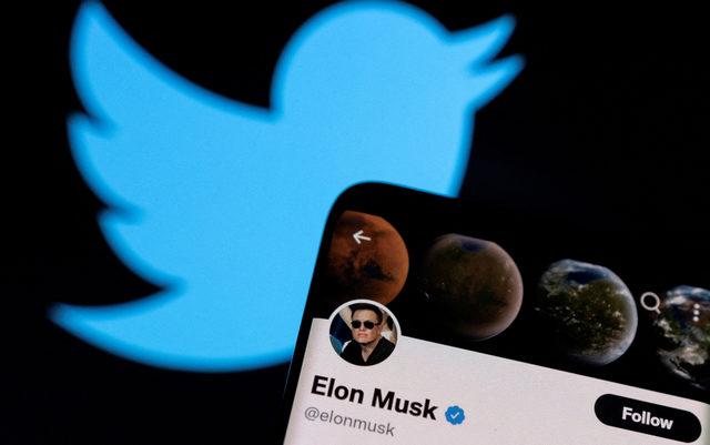 FILE PHOTO: A photo illustration shows Elon Musk's Twitter account and the Twitter logo