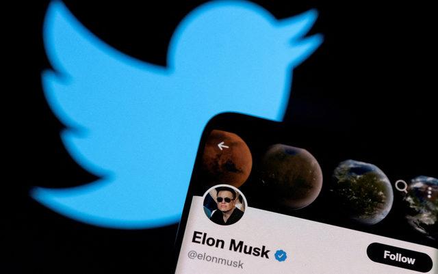 FILE PHOTO: FILE PHOTO: FILE PHOTO: A photo illustration shows Elon Musk's Twitter account and the Twitter logo