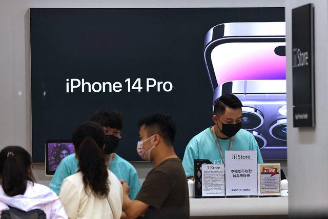 Customers visit an Apple store in Taipei,
