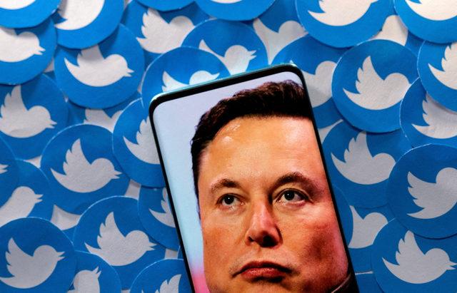 FILE PHOTO: FILE PHOTO: Illustration shows Elon Musk image on smartphone and printed Twitter logos