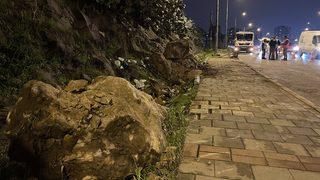 İzmir'de yağış nedeniyle koparak yola düşen kaya parçaları seyir halindeki otomobile zarar verdi