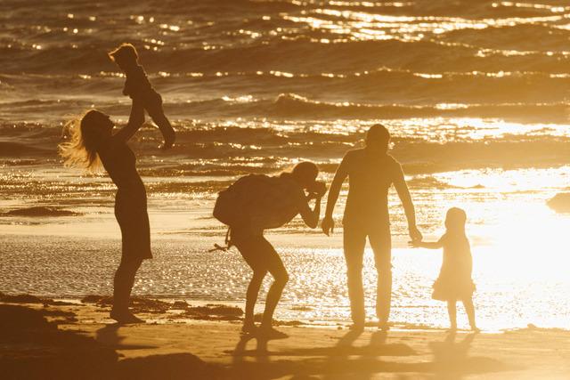 FILE PHOTO: People enjoy low tide during sunset in Solana Beach, California