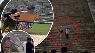 Kutsal tapınağa izinsiz bir şekilde çıkan turisti elindeki sopayla bekledi! Yanına yaklaşıp bir anda kafasına vurdu