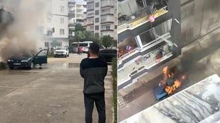 Yanan araca, balkondan böyle müdahale etti! Kova kova su döktü