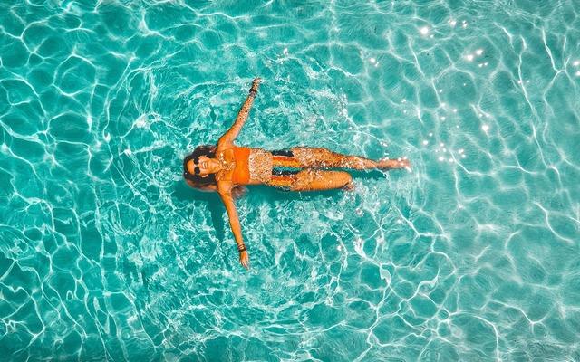 woman-in-colorful-suit-on-back-in-water-drew-dau-GA2sc8nIOsk-unsplash-960x600-89984951