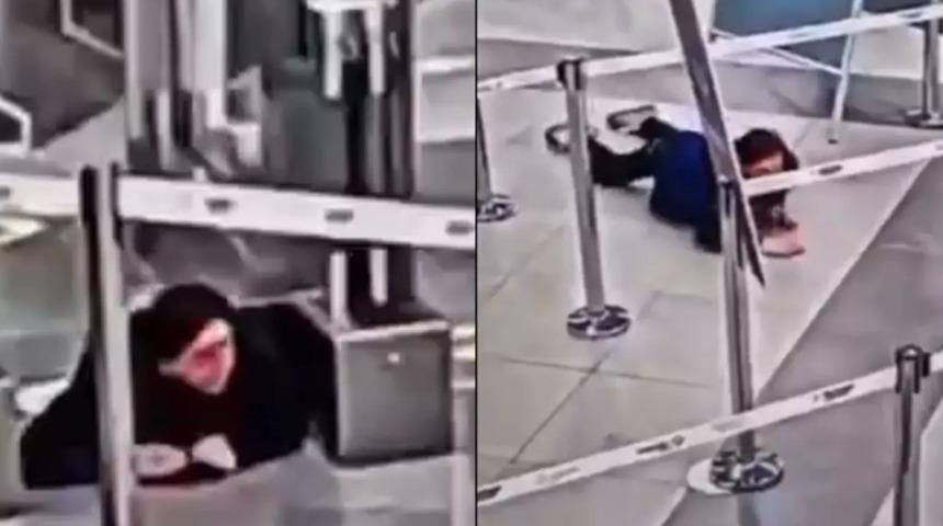 Şaşkına çeviren güvenlik kamerası görüntüleri! Güvenlik bariyerinin altından sürünerek geçip fark edilmeden uçağa bindi 