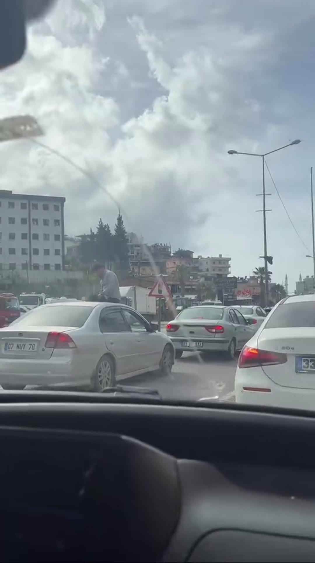 Akan trafikte canını hiçe saydı... Aracın tavanına çıkıp karşısında birisi varmış gibi sohbet etti 3