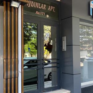 Apartman kapısının camını taş fırlatarak kırdılar