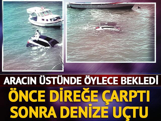 Direksiyon hakimiyetini kaybedip denize uçtu! Aracın üstünde kurtarılmayı bekledi