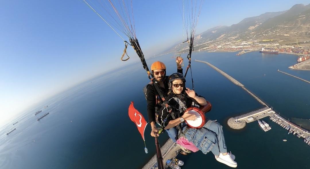 Hatay da yamaç paraşütüyle atlayan kadın gökyüzünde darbuka çaldı 1