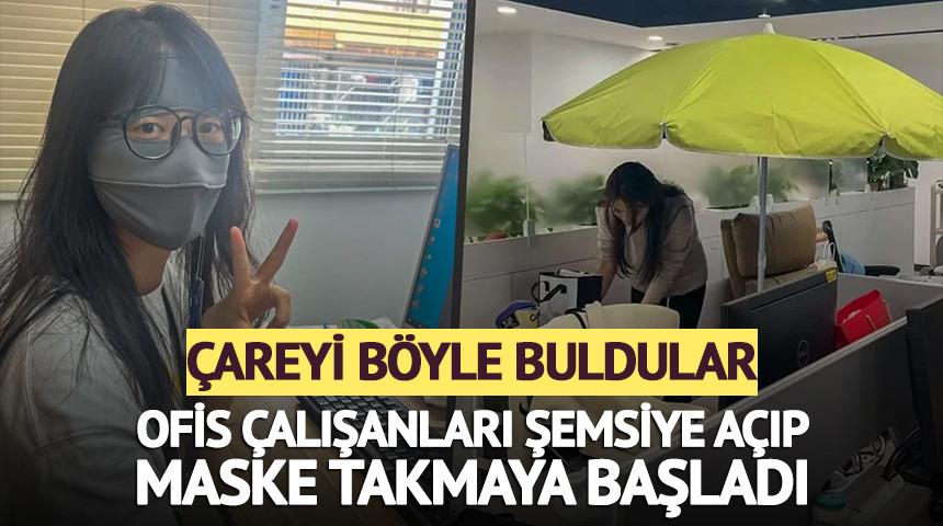 Ofis &ccedil;alışanları şemsiye a&ccedil;ıp maske takıyor! İşte şaşırtan nedeni