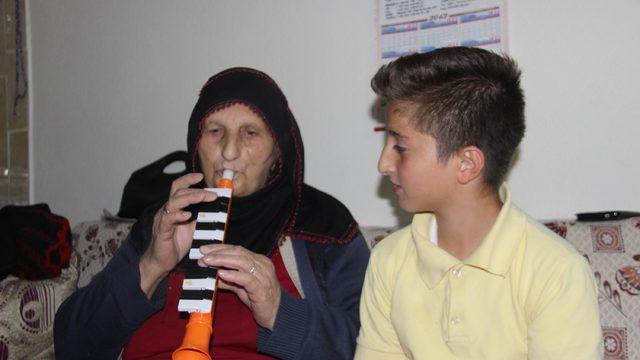 Müşkünaz nine, torununa melodika çalmayı öğretiyor